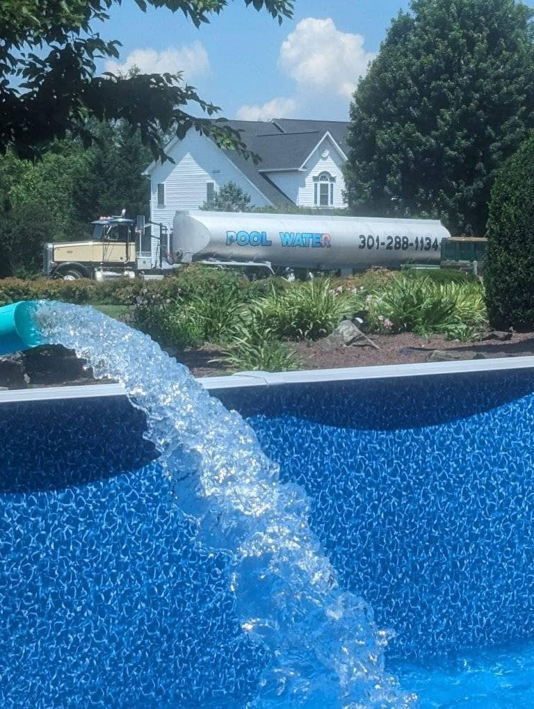 Pool water delivery truck filling a backyard swimming pool in Frederick, MD